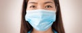 Asian woman wearing protective mask and looking at the camera. Concept of protect yourself and others from coronavirus contagion