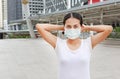 Asian woman wearing protective mask to protect virus, pollution and the flu at public area Royalty Free Stock Photo