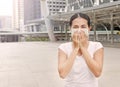 Asian woman wearing protective mask to protect virus, pollution and the flu at public area Royalty Free Stock Photo