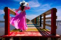 Asian women wearing purple dresses are standing on the bridge at Rainbow Bridge, Kalong village, Samut Sakhon province, Thailand