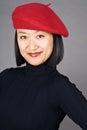 Asian Woman Wearing a Red Beret Royalty Free Stock Photo