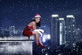 Asian woman wearing santa claus costume sit on the rooftop Royalty Free Stock Photo
