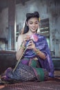 Asian woman wearing Thai traditional dress hand holding lotus flower Royalty Free Stock Photo