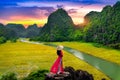 Asian woman wearing Vietnam culture traditional at Tam coc, Vietnam