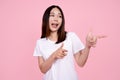 Asian woman wearing a white shirt uses her hand to point a promotion or copy space Royalty Free Stock Photo