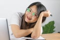 Asian woman wearing a white T-shirt and wearing glasses to work at home with happy emotions Have eyes looking at the camera and