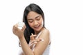 asian woman wearing white underdress using body cream rub into arm Royalty Free Stock Photo