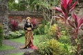woman wearing a woven sarong in a traditional Balinese garden Royalty Free Stock Photo