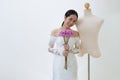 Asian woman in wedding dress with male mannequin.1 Royalty Free Stock Photo