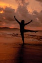 an Asian woman who is playing and dancing on the beach with strong waves Royalty Free Stock Photo