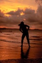 an Asian woman who is playing and dancing on the beach with strong waves Royalty Free Stock Photo