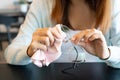 Asian woman wipes her glasses with a cloth. Cleaning glasses. Closeup