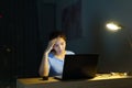 Asian woman work late at night stressful with project research problems on a laptop computer or notebook at home office  burnout Royalty Free Stock Photo