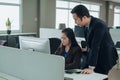 Asian woman worker with coworker working together in company office