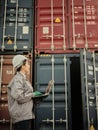 Asian woman worker holding Laptop and inspection container Royalty Free Stock Photo