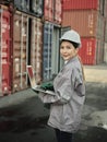 Asian woman worker holding Laptop and inspection container Royalty Free Stock Photo