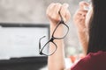 Asian woman worker suffering from eye strain tired from working on computer screen