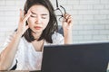 Asian woman worker suffering from eye strain hand holding eyeglasses