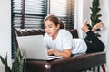 Asian woman working from home using Laptop and drinking coffee in her bedroom Royalty Free Stock Photo