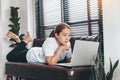 Asian woman working from home using Laptop and drinking coffee in her bedroom Royalty Free Stock Photo