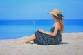 asian woman working on laptop on the tropical beach Royalty Free Stock Photo