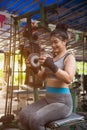 Asian woman working out with dumbbell weights at the gym.Fitness Women exercising are lifting dumbbells in gym. Royalty Free Stock Photo