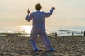 Asian woman working out with Tai Chi in the morning before sunrise at the beach near sea on the city Da nang, Vietnam Royalty Free Stock Photo