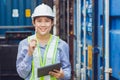 Asian woman working in shipping logistic cargo loading area checking customs of import export container portrait smiling