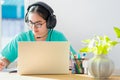 Asian woman writing notes at book learning online Royalty Free Stock Photo