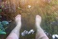 Asian woman& x27;s foot soaked in mineral water, a soothing mood for a foot spa concept