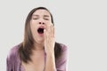 Asian woman yawning.