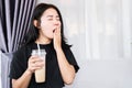 Closeup Asian woman yawning feeling sleepy after drinking coffee, tired after caffeine Royalty Free Stock Photo