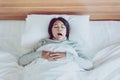 Asian woman yawning on her bedroom and tired sleepy,Symptoms and sleepiness