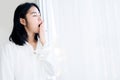 Sleepless Asian woman yawning after waking up in the morning feeling tired and sleepy Royalty Free Stock Photo