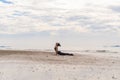 An Asian woman in yoga class club doing exercise and yoga at natural beach and sea coast outdoor in sport and recreation concept. Royalty Free Stock Photo