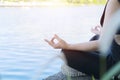 Asian woman Yoga - relax in nature. Young woman meditates while practicing yoga Royalty Free Stock Photo