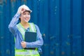 Asian woman young teen happy smile worker as engineer working with safety in logistic import export warehouse cargo container area