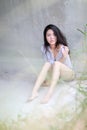 Asian womansitting outdoor in countryside. Young smiling woman outdoors portrait. Royalty Free Stock Photo