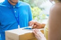 Asian woman accepting receive a delivery of boxes from delivery asian man Royalty Free Stock Photo