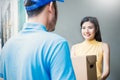 Asian woman accepting receive a delivery of boxes from delivery asian man Royalty Free Stock Photo