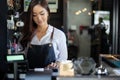 Asian women Barista smiling and using coffee machine in coffee shop counter - Working woman small business owner food and drink Royalty Free Stock Photo