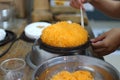 Asian women chefs are making colorful fios de ovos cakes, Thai style cakes.