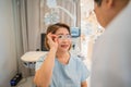 Client testing her new eyeglasses with optometrist in optical store Royalty Free Stock Photo