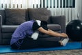 Asian women do stretching exercises after taking yoga classes while at home