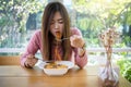 Asian women eating korean noodles using fork at restaurant Royalty Free Stock Photo