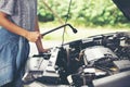 Asian women engineer holding a wrench in hand, prepared for the repairs cars on road