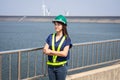 Asian women engineer stands confidently at outdoor on site power plant energy