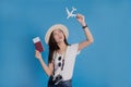 Asian women enjoying their passports and travel tickets on a blue background. Travel concept Royalty Free Stock Photo