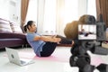 Asian women exercise workout at home, With recording making video Royalty Free Stock Photo