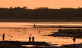 Asian women fishing in the river, silhouette at sunset